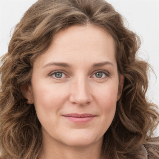 Joyful white young-adult female with long  brown hair and green eyes