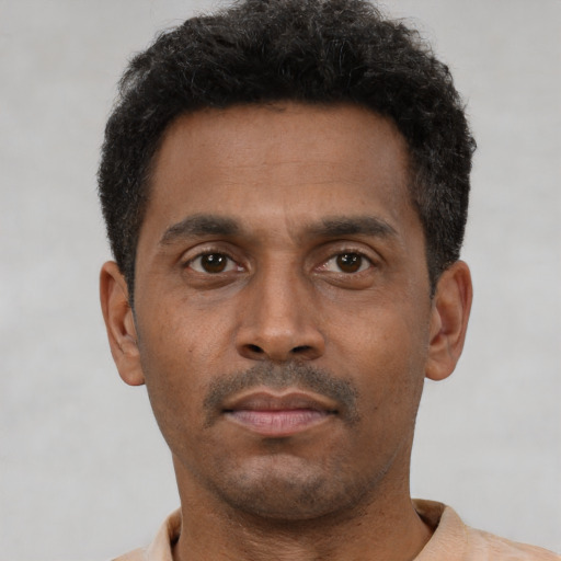 Neutral latino young-adult male with short  brown hair and brown eyes