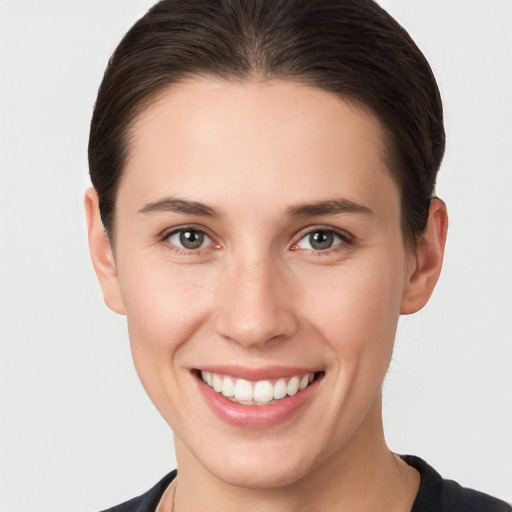 Joyful white young-adult female with short  brown hair and brown eyes