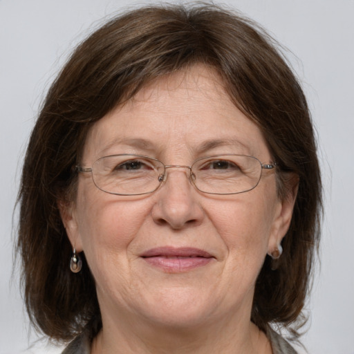 Joyful white middle-aged female with medium  brown hair and grey eyes