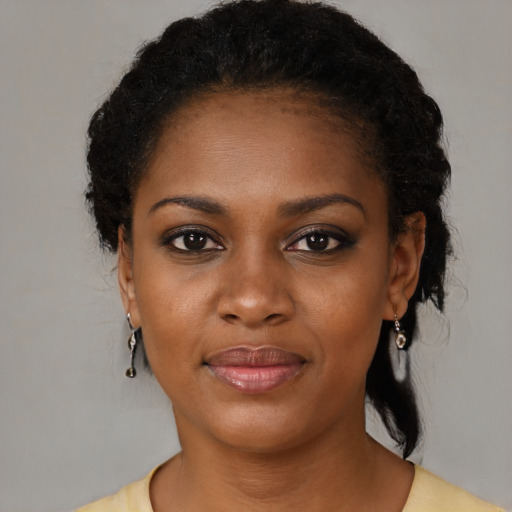Joyful black young-adult female with medium  brown hair and brown eyes