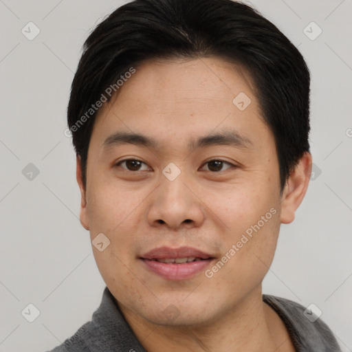 Joyful asian young-adult male with short  black hair and brown eyes