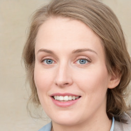 Joyful white young-adult female with medium  brown hair and blue eyes