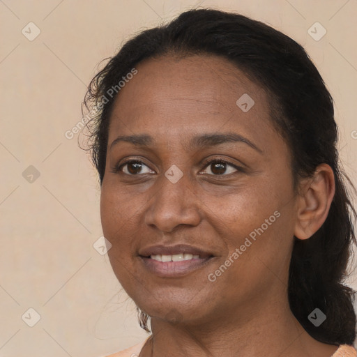 Joyful black adult female with medium  brown hair and brown eyes