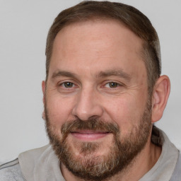 Joyful white adult male with short  brown hair and brown eyes