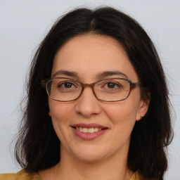 Joyful white adult female with long  brown hair and brown eyes