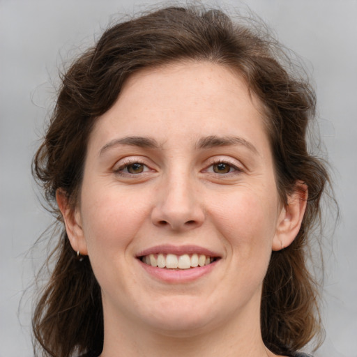 Joyful white young-adult female with medium  brown hair and green eyes