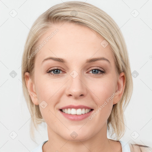 Joyful white young-adult female with medium  brown hair and blue eyes