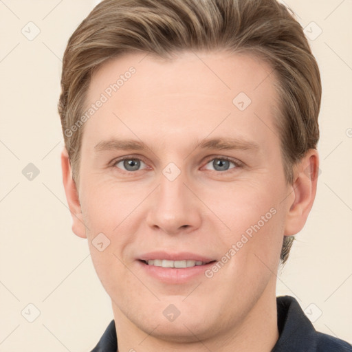 Joyful white young-adult male with short  brown hair and grey eyes