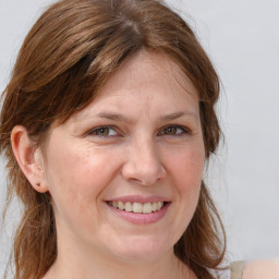 Joyful white adult female with medium  brown hair and grey eyes