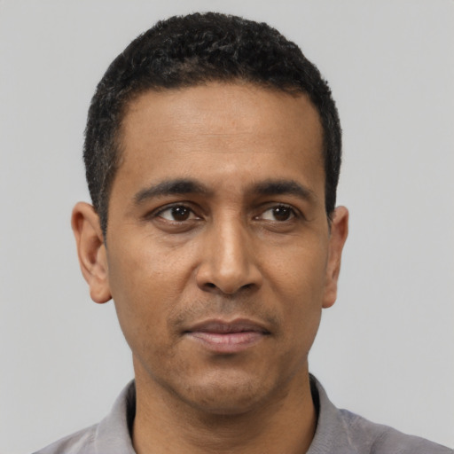 Neutral latino adult male with short  black hair and brown eyes