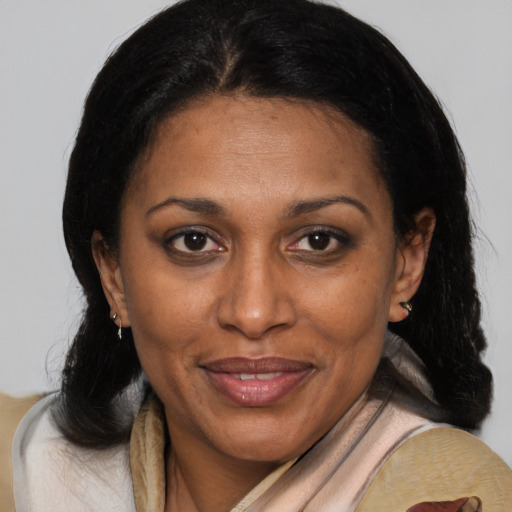Joyful black adult female with medium  brown hair and brown eyes