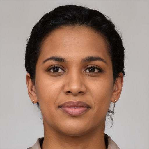 Joyful latino young-adult female with short  black hair and brown eyes