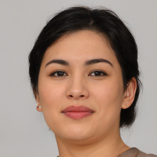 Joyful asian young-adult female with medium  brown hair and brown eyes