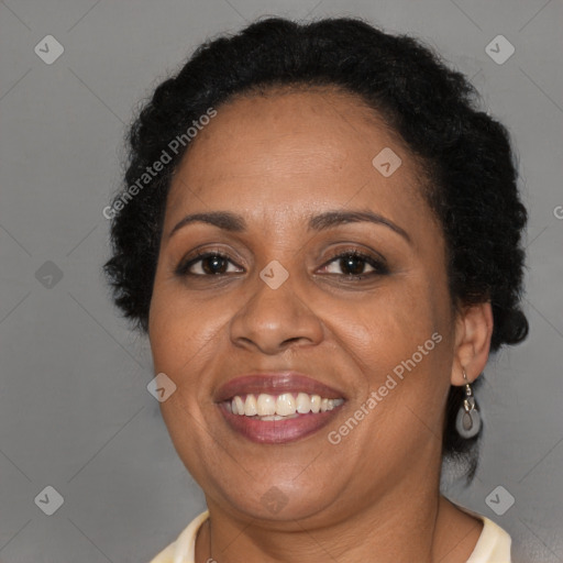 Joyful black adult female with medium  brown hair and brown eyes