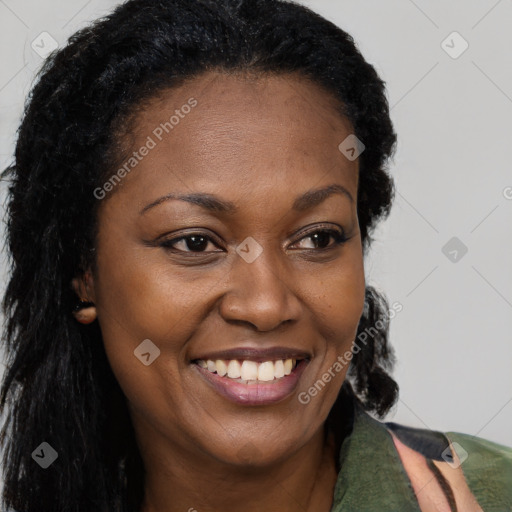 Joyful black young-adult female with long  brown hair and brown eyes