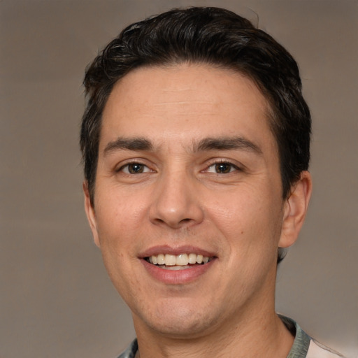 Joyful white adult male with short  brown hair and brown eyes