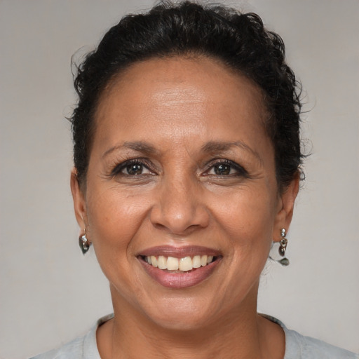 Joyful black adult female with short  brown hair and brown eyes