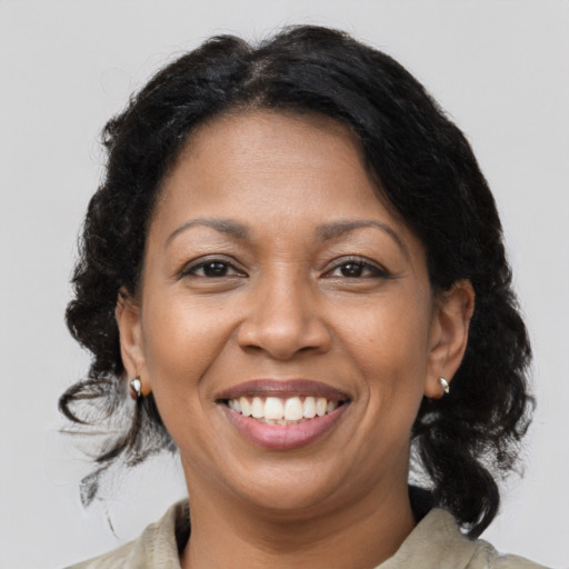 Joyful latino adult female with medium  brown hair and brown eyes