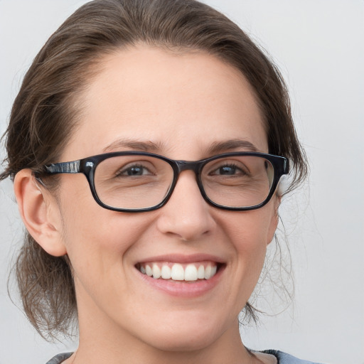 Joyful white young-adult female with medium  brown hair and blue eyes