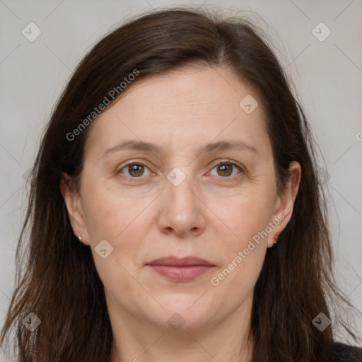 Joyful white adult female with long  brown hair and brown eyes