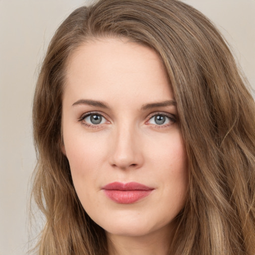 Joyful white young-adult female with long  brown hair and green eyes