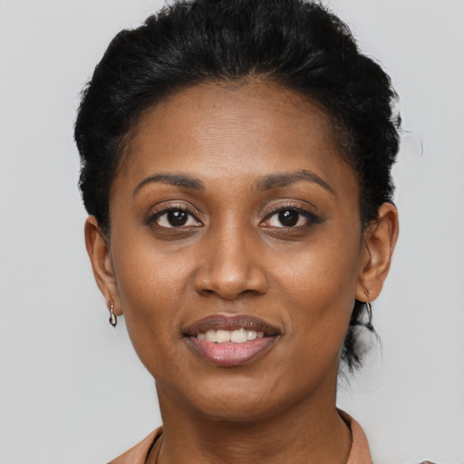 Joyful black adult female with short  black hair and brown eyes