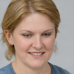 Joyful white young-adult female with medium  brown hair and blue eyes