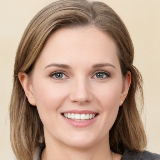 Joyful white young-adult female with medium  brown hair and grey eyes