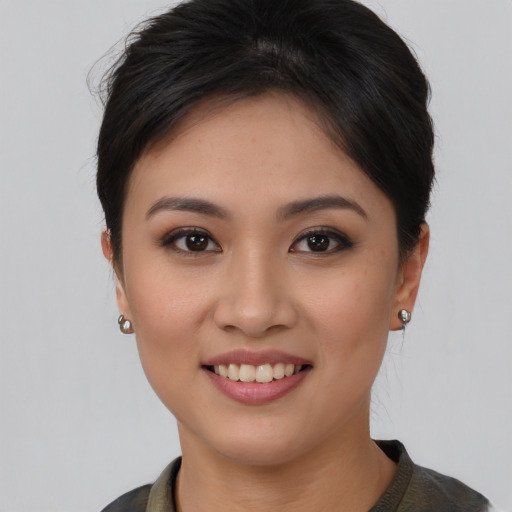 Joyful asian young-adult female with short  brown hair and brown eyes