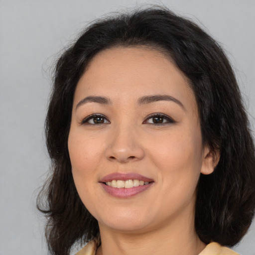 Joyful asian young-adult female with medium  brown hair and brown eyes