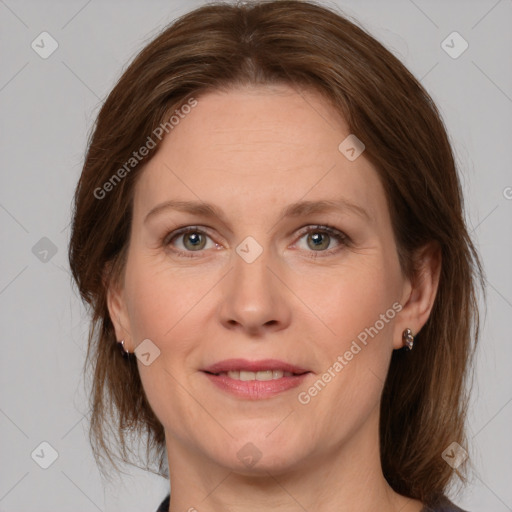 Joyful white adult female with medium  brown hair and grey eyes