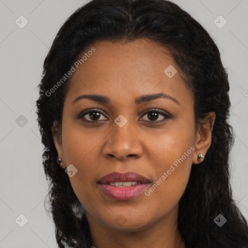 Joyful black young-adult female with long  brown hair and brown eyes