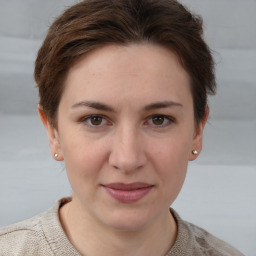 Joyful white young-adult female with short  brown hair and grey eyes