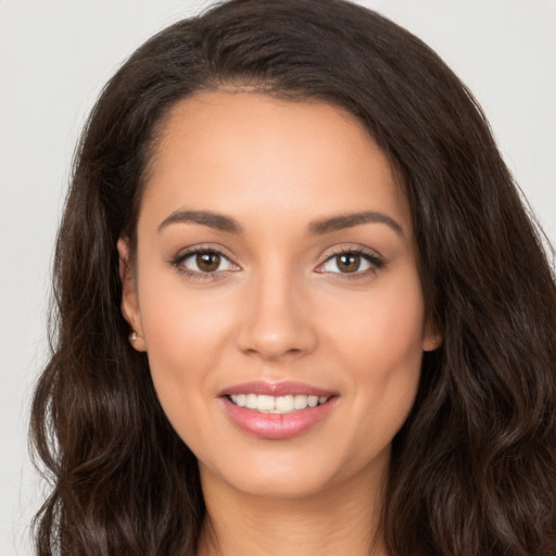 Joyful white young-adult female with long  brown hair and brown eyes