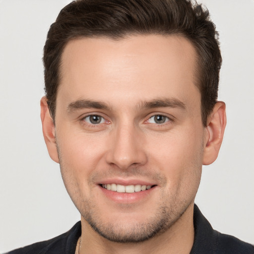 Joyful white young-adult male with short  brown hair and brown eyes