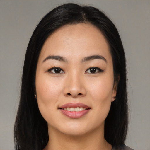Joyful asian young-adult female with long  black hair and brown eyes