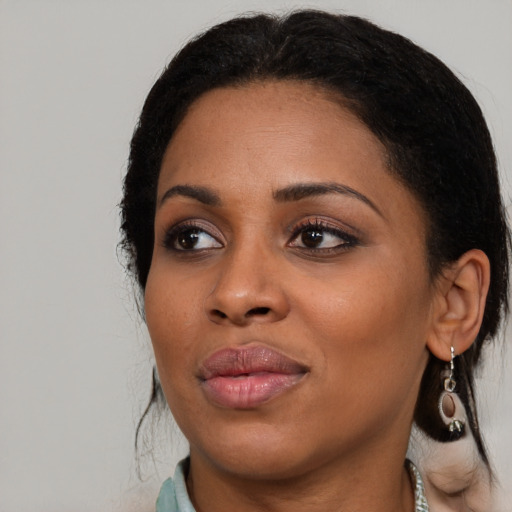 Joyful black young-adult female with medium  black hair and brown eyes