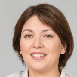 Joyful white adult female with medium  brown hair and brown eyes