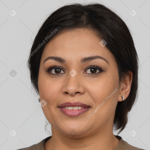 Joyful latino adult female with medium  brown hair and brown eyes