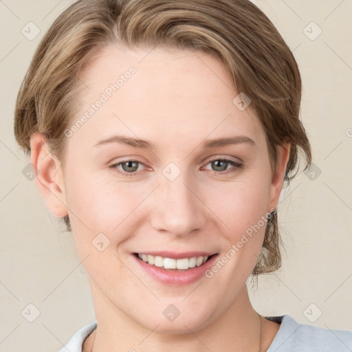 Joyful white young-adult female with medium  brown hair and blue eyes