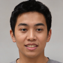 Joyful asian young-adult male with short  black hair and brown eyes