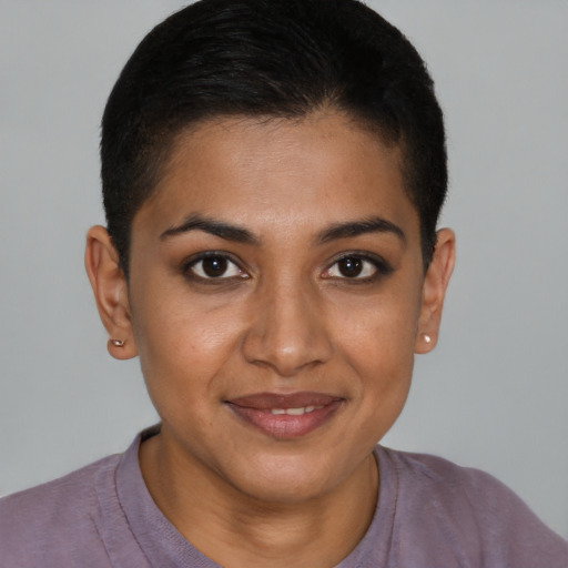 Joyful black young-adult female with short  brown hair and brown eyes