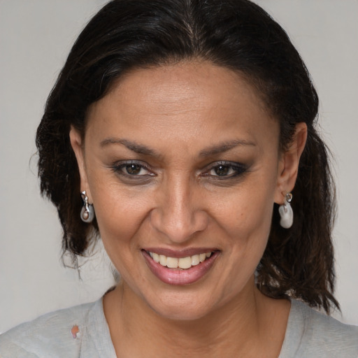 Joyful black adult female with medium  brown hair and brown eyes