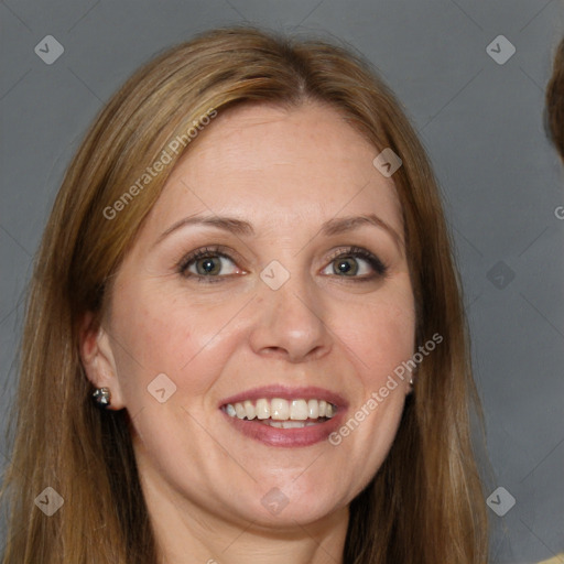 Joyful white adult female with long  brown hair and brown eyes