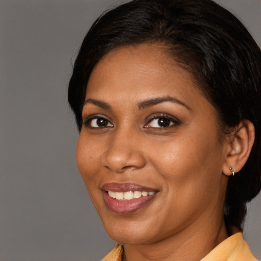 Joyful black young-adult female with medium  brown hair and brown eyes