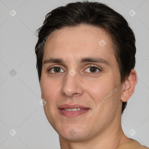 Joyful white adult male with short  brown hair and brown eyes