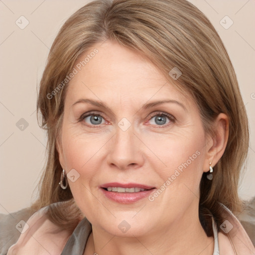 Joyful white adult female with medium  brown hair and grey eyes