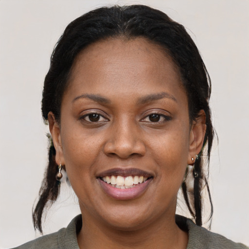 Joyful black young-adult female with medium  brown hair and brown eyes