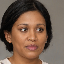 Joyful black adult female with medium  brown hair and brown eyes